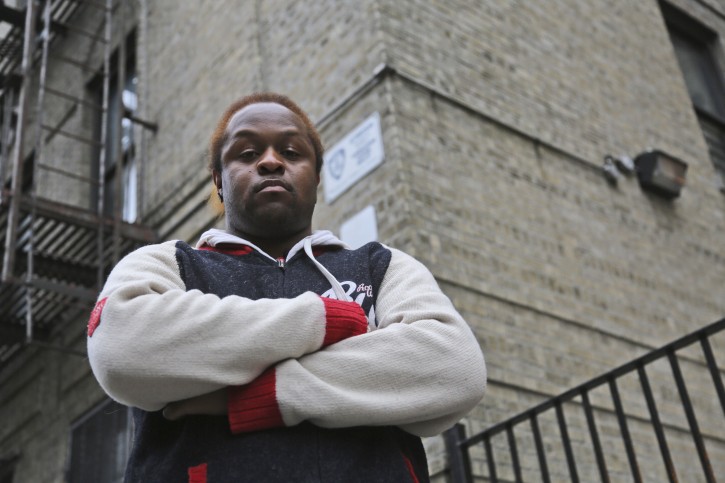 In this Wednesday, March 6 2013 photo,  Abdullah Turner poses for a photo outside his building in the Bronx borough of New York.   Turner lives in one of thousands of private dwellings patrolled by the New York Police Department under a program known as "Operation Clean Halls." (AP Photo/Mary Altaffer)