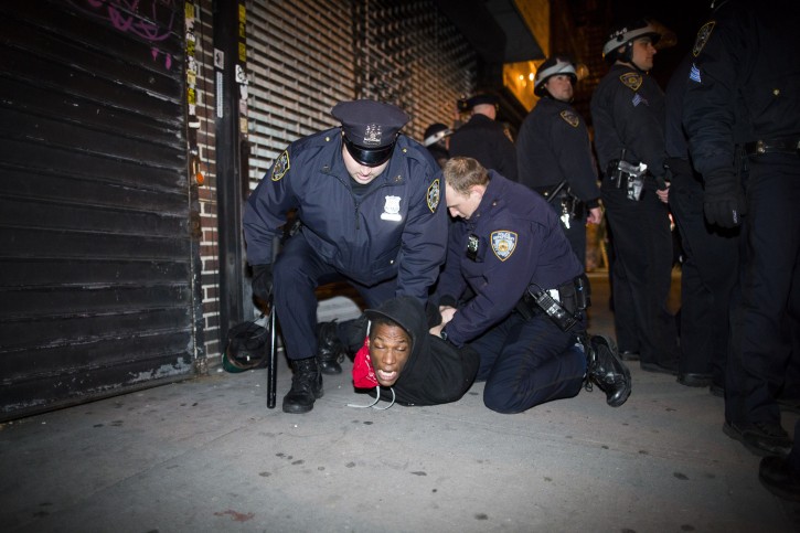 Police officers arrest a demonstrator during a march after a vigil held for Kimani Kiki Gray in the East Flatbush neighborhood of Brooklyn, Wednesday, March 13, 2013. (AP Photo/John Minchillo)