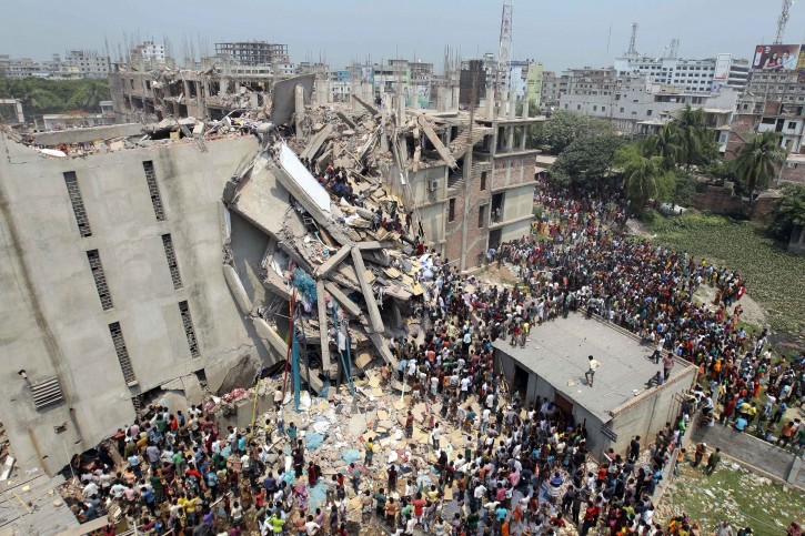 People and rescuers gather after an 8-story building housing several garment factories collapsed near Dhaka, Bangladesh, Wednesday, April 24, 2013. Dozens were killed and many more are feared trapped in the rubble. (AP Photo/ A.M. Ahad)
