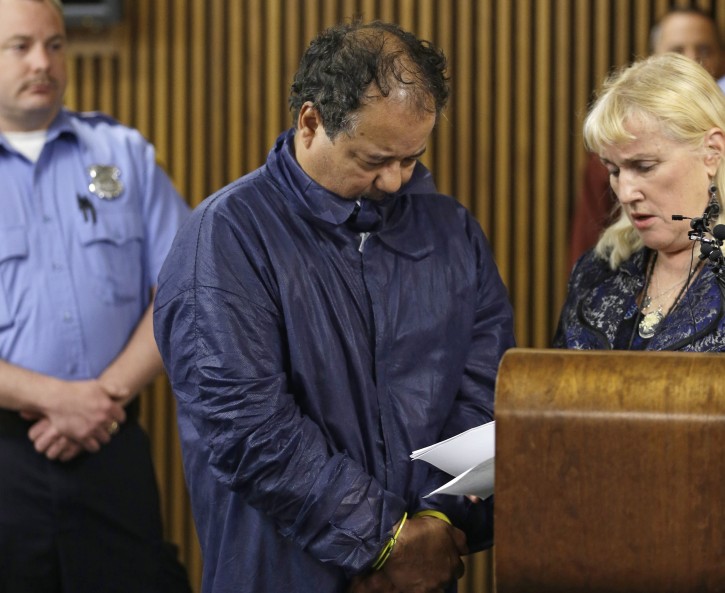 Ariel Castro appears in Cleveland Municipal court alongside defense attorney Kathleen DeMetz, right, Thursday, May 9, 2013, in Cleveland. Castro was charged with four counts of kidnapping and three counts of rape after three women missing for about a decade and one of their young daughters were found alive at his home earlier in the week. (AP Photo/Tony Dejak)