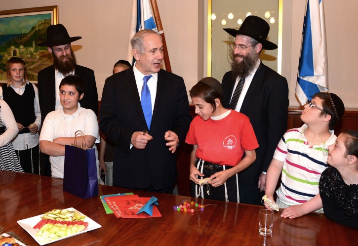 Israel's Prime Minister Benjamin Netanyahu (C) meets with children of the "Lend a Hand To a Special Child" group in his office Jerusalem on May 29, 2013. Netanyahu met with special needs children about to celebrate their Bar and Bat Mitzvah in his office Wednesday. Photo by Moshe Milner/ GPO/Flash 90. 