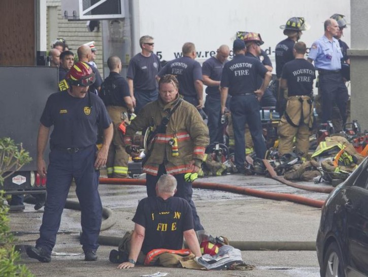 Firefighters gather at the scene of a fire where four firefighters were killed battling a a five-alarm blaze at a restaurant and hotel in southwest Houston May 31, 2013.     REUTERS/Richard Carson