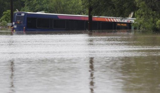 | A San Antonio metro bus sits in floodwaters after it was swept off the road during heavy rains in San Antonio. (May 25, 2013) AP