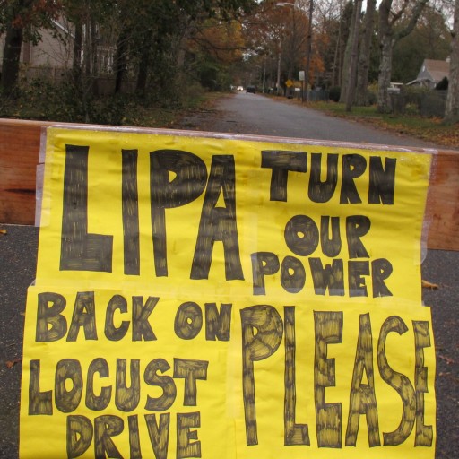 A plea to the Long Island Power Authority for electricity to be restored is posted on a barrier in Mastic Beach, N.Y. on Oct. 31, 2012. (AP)