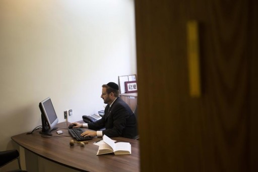 FILE - Dov Lipman, a member of Knesset, the Israeli parliament, works at his office in Jerusalem June 6, 2013.  Reuters