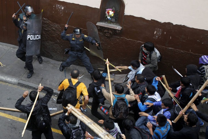 Students clash with riot police during a demonstration against the government in Lima, Peru, 5 July, 2013. Photograph: Enrique Castro-mendivil/Reuters 