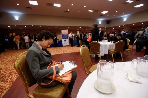 A woman filling out a job application at a job fair in New York on June 11.
(Lucas Jackson/Reuters)