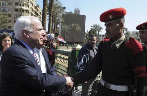 File photo of Senator John McCain greeting an Egyptian military police officer during his visit to Tahrir Square, in Cairo, Egypt, Sunday, Feb. 27, 2011. (AP Photo/Mohammed Ismail) 