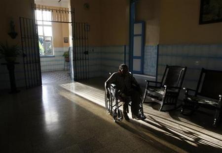 An elderly man rolls along in his wheelchair.
Credit: Reuters/Enrique De La Osa