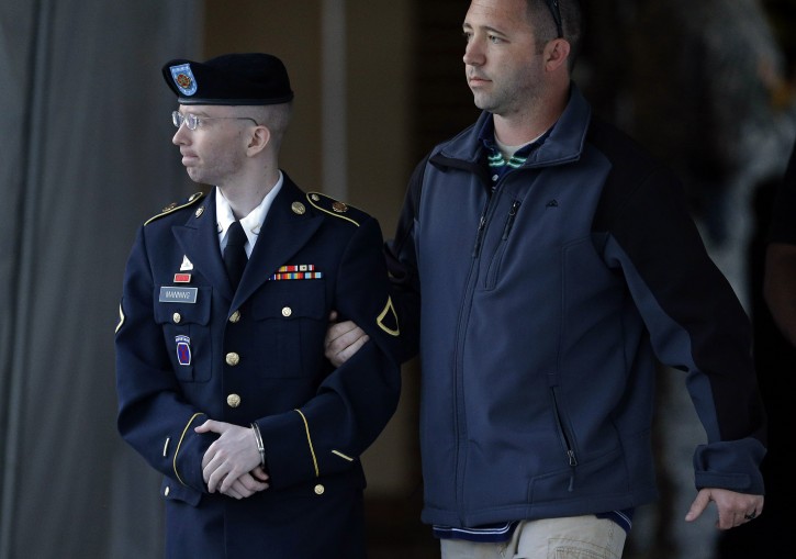 Army Pfc. Bradley Manning, left, is escorted to a security vehicle outside of a courthouse in Fort Meade, Md., Monday, July 29, 2013. (AP Photo/Patrick Semansky)