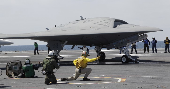 FILE - A Navy X-47B drone is launched off the nuclear powered aircraft carrier USS George H. W. Bush off the coast of Virginia, in this May 14, 2013 file photo. The Navy says the X-47B experimental aircraft will try to land aboard the USS George H.W. Bush on Wednesday July 10, 2013. (AP Photo/Steve Helber, File)
