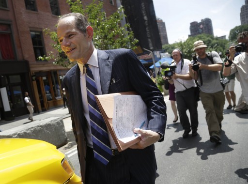 Former New York Gov. Eliot Spitzer walks to a cab after trying to collect signatures for his run for New York City comptroller in Union Square in New York, Monday, July 8, 2013. Spitzer, who stepped down in 2008 amid a prostitution scandal, says he is planning a political comeback with a run for New York City comptroller. (AP Photo/Seth Wenig)