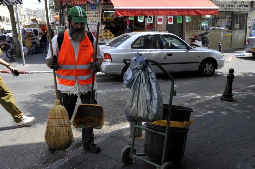 FILE - Ultra orthodox jew work as a street cleaner  in Florentin Market  in Tel Aviv Sept 26 2010 Photo by Serge Attal / Flash 90