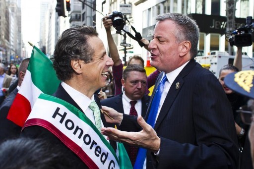 FILE - New York City mayoral-elect Bill de Blasio (R) speaks with New York Governor Andrew Cuomo while they attend the 69th Annual Columbus Day Parade in New York, October 14, 2013.    REUTERS/Eduardo Munoz 