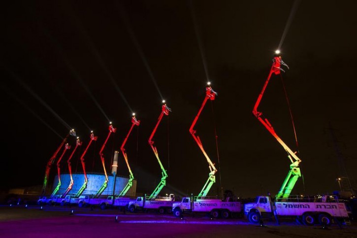 The lights are turned on for a giant menorah at the Reading Power Station in Tel Aviv, on the Jewish holiday of Hanukkah December 4, 2013. Israel's electric company said on Wednesday it had created the world's largest menorah consisting of nine aerial platforms reaching 28 meters and lit with nine white light beams reaching the height of ten kilometers. Hanukkah, also known as the Festival of Lights and one of the most important Jewish holidays came to an end on Wednesday. REUTERS/Nir Elias
