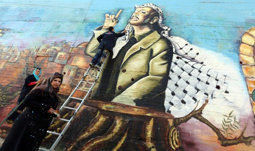 FILE -  Palestinian artists paint a huge mural depicting the late Palestinian leader Yasser Arafat in the West Bank city of Nablus, 11 November 2013. EPA