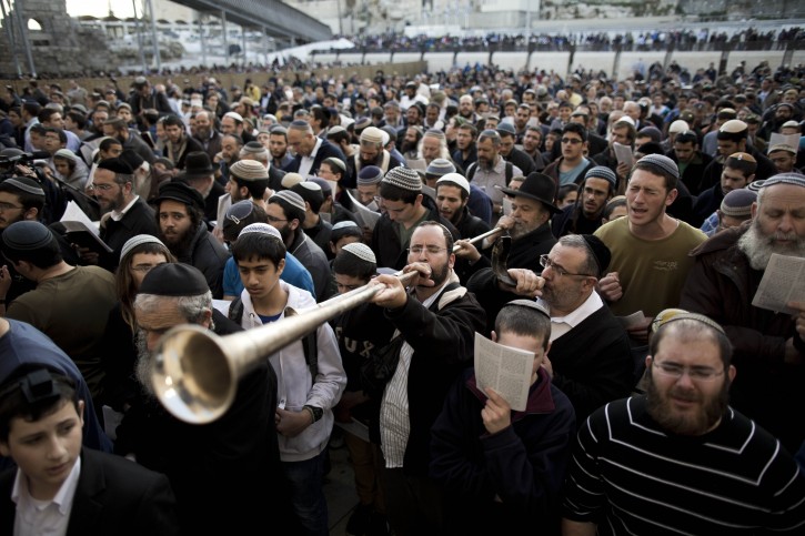  A Jewish man blows a trumpet at the Western Wall during a special prayer organized by a Israeli  right-wing Knesset member in Jerusalems's Old City, 30 January 2014. The prayer was organized against the ongoing negotiations with the Palestinians.  EPA/ABIR SULTAN