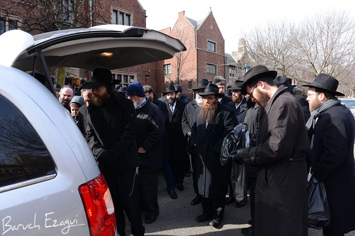 On Thursday the funeral procession drives past Chabad headquarters at 770 . (Baruch Ezagui/VINnews.com)