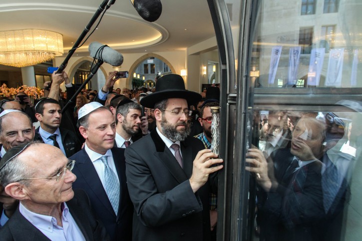 Ashkenazi Chief Rabbi of Israel David Lau, and Mayor of Jerusalem, Nir Barkat, install a new Mezuzah at the official opening of the Waldorf Astoria hotel's Jerusalem branch on Agron Street, near the Old City, on Thursday, March 27, 2014. Photo by Flash 90.