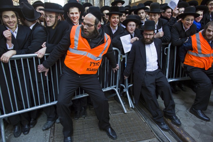 Barricades are secured as thousands of Orthodox Jews gathered in New York, Sunday, March 9, 2014, on Water Street in lower Manhattan, to pray and protest against the Israeli government's proposal to pass a law that would draft strictly religious citizens into its army. (AP Photo/Craig Ruttle)