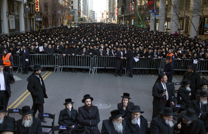Thousands of Orthodox Jews gather in New York, Sunday, March 9, 2014, on Water Street in lower Manhattan, to pray and protest against the Israeli government's proposal to pass a law that would draft strictly religious citizens into its army. (AP Photo/Craig Ruttle)