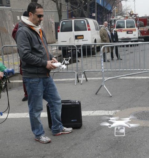 A camera drone flown by Brian Wilson lands near the scene where two buildings were destroyed in an explosion, in the East Harlem section in New York City, March 12, 2014. Two New York buildings collapsed on Wednesday in an explosion believed to be caused by a gas leak, killing two people, injuring at least 22, and setting off a search for more feared trapped in the debris, officials said.  REUTERS/Mike Segar   