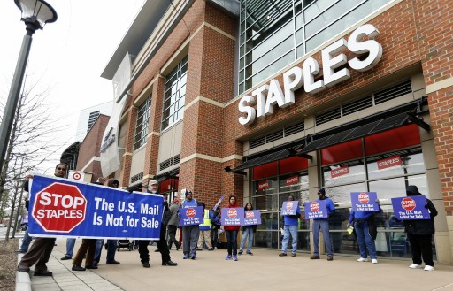 FILE - US Postal Service (USPS) employees picket in front of a Staples office supply store in Atlanta, Georgia, USA, 04 March 2014. EPA/ERIK S. LESSER