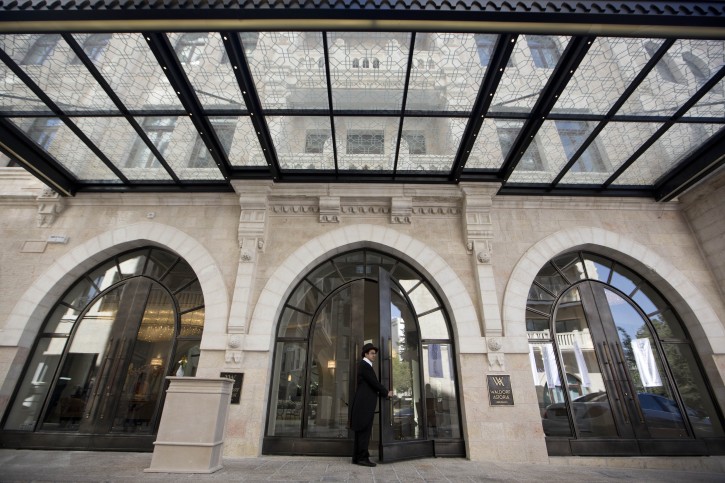 An Israeli doorman stands at lobby entrance of the Waldorf Astoria Hotel in Jerusalem, Israel, 27 March 2014. After more than seven years of construction, the luxury hotel chain Waldorf Astoria opened its first branch in Israel, at the site of the historic Palace Hotel which was constructed in 1928-29. The hotel was rebuilt of Jerusalem stone.  EPA/ABIR SULTAN