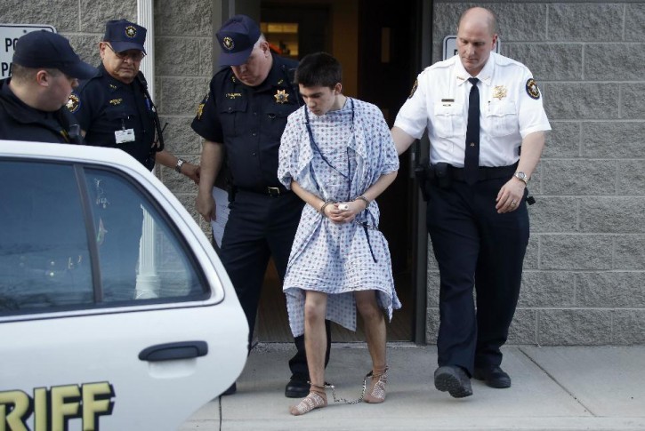 Alex Hribal, the suspect in the stabbings at the Franklin Regional High School near Pittsburgh, is taken from a district magistrate after he was arraigned on charges in the attack on Wednesday, April 9, 2014 in Export, Pa. (AP Photo/Keith Srakocic)