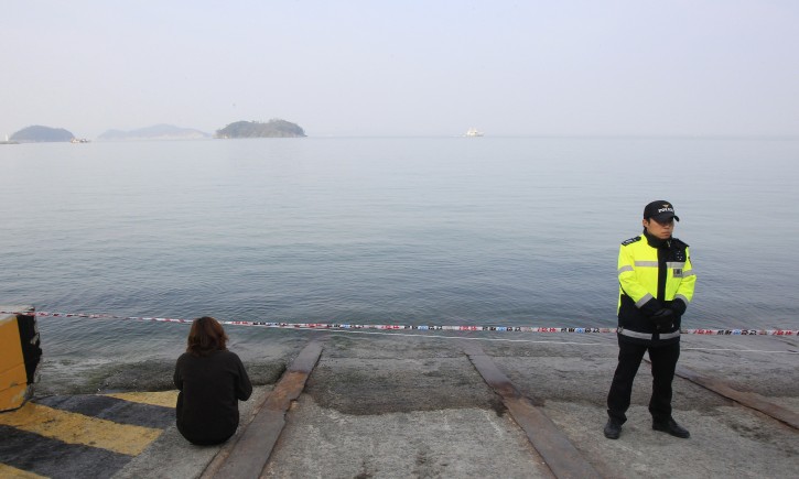 A  relative of a passenger aboard the sunken Sewol ferry looks toward the sea as she awaits news on her missing loved one at a port in Jindo, South Korea, Thursday, April 24, 2014. Divers made their way deeper Thursday into the submerged wreck of a ferry that sank more than a week ago as the death toll neared 160 and relatives of the more than 140 still missing pressed the government to finish the grim task of recovery soon.(AP Photo/Ahn Young-joon)
