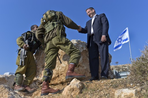 File - Israeli lawmaker Rabbi Dov Lipman (R) from the Yesh Atid party, shakes hands with Israeli soldiers as he takes part in a tour of Jordan Valley Jewish settlements new Maale Efraim, Israel, 02 January 2014. EPA