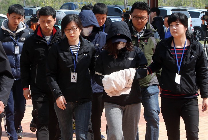 More ferry crew face arrest Four crew members of the sunken ferry Sewol enter a court in Mokpo in southwestern South Korea, 24 April 2014, to be questioned on charges of causing the deaths of passengers through abandonment. The ship's captain and six other crew members have already been put under arrest on the similar charges.  EPA/YONHAP