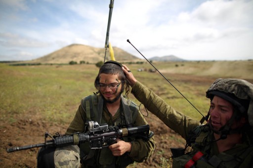  Israeli soldiers from the Netzach Yehuda brigade, the Israeli army battalion for Orthodox soldiers and Yeshiva students, in action during the battalion ground maneuver exercise in the Golan Heights near the Israeli-Syrian border, 19 May 2014. EPA/ABIR SULTAN