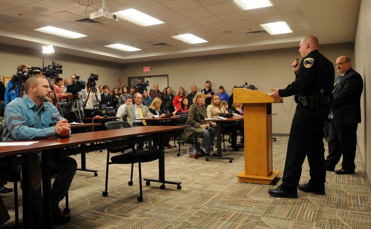 Media and community members listen as Waseca Police Capt. Kris Markeson, flanked by Waseca School Superintendent Thomas Lee, answers questions Thursday, May 1, 2014. Police arrested a 17-year-old suspect Tuesday and charged him in juvenile court Thursday, with four counts of attempted first-degree murder, six counts of possessing explosive or incendiary devices and two counts of criminal damage to property. (AP Photo/The Mankato Free Press, John Cross)