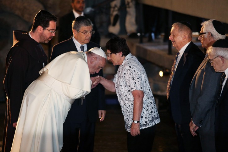 Pope Francis (3-L) kisses the hand of Holocaust Survivor Chava Shik (4-R) during a memorial ceremony in the Hall of Remembrances in the Yad Vashem Holocaust memorial in Jerusalem, Israel, 26 May 2014. Pope Francis honored the six-million Jews who perished at the hands of the Nazis during the Holocaust of World War II. Pope Francis is on a two days visit in Israel.  EPA/ABIR SULTAN