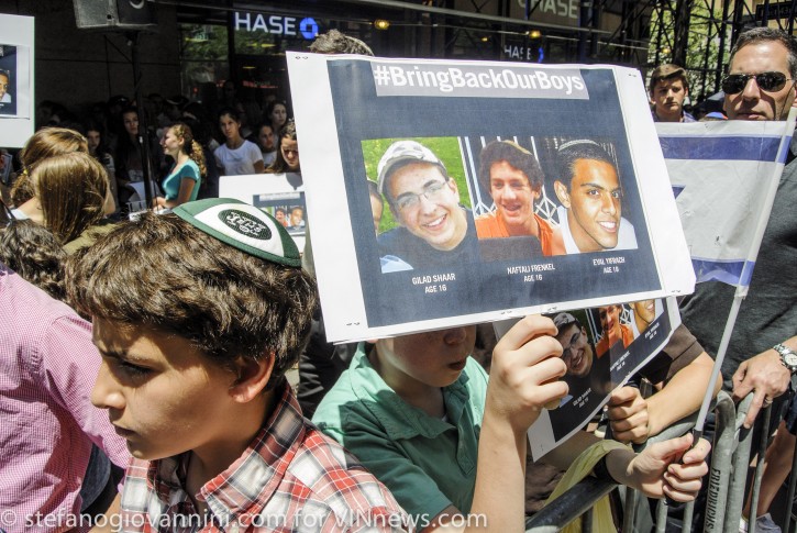 A group of teenagers holds up a sign with images of three teenagers missing in West Bank, while taking part in a demonstration demanding for their safe return outside the Israeli Consulate in Manhattan, New York June 16, 2014 (Stefano Giovannini /VINnews.com)