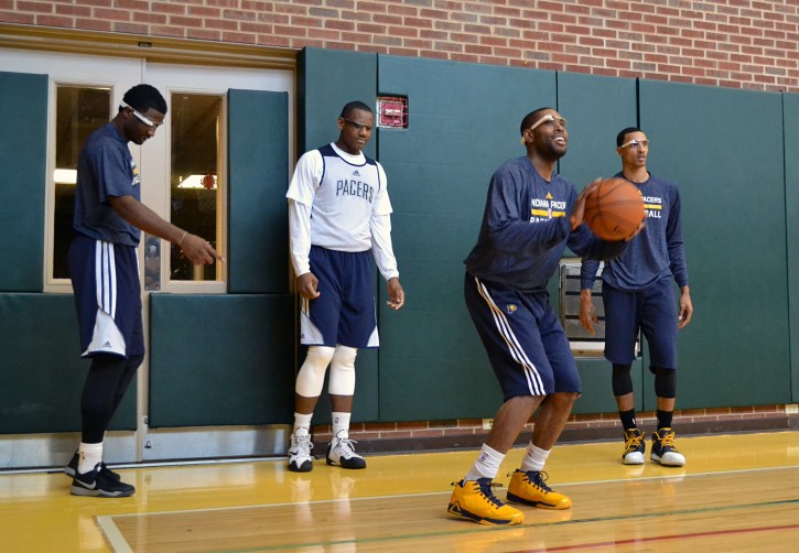 In this March 25, 2014 photo provided by Pacers.com, Indiana Pacers basketball players, from left,  Solomon Hill, Lavoy Allen, C.J. Watson and George Hill wear Google glasses during practice at Bankers Life Fieldhouse in Indianapolis. Google Glass is slowly becoming more common in sports as teams and broadcasters try to bring fans closer to the action. (AP Photo/Pacers.com, Celeste Ballou)