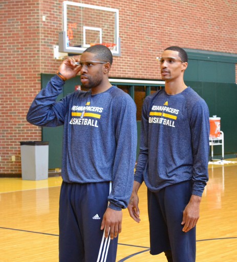 In this March 25, 2014 photo provided by Pacers.com, Indiana Pacers basketball players C. J. Watson, left, George Hill, center, and Lavoy Allen, at right back to camera, wear Google glasses during practice at Bankers Life Fieldhouse in Indianapolis. Google Glass is slowly becoming more common in sports as teams and broadcasters try to bring fans closer to the action. (AP Photo/Pacers.com, Celeste Ballou)