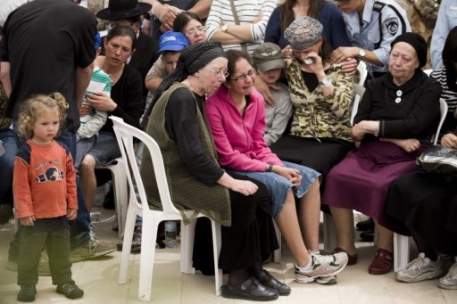 Hadas Mizrahi (C) the widow of Israeli police officer Baruch Mizrahi, 47, is surrounded by family and close friends, during the funeral of her husband at the military cemetery of Mount Herzl in Jerusalem, Israel, 16 April 2014. EPA/ABIR SULTAN 