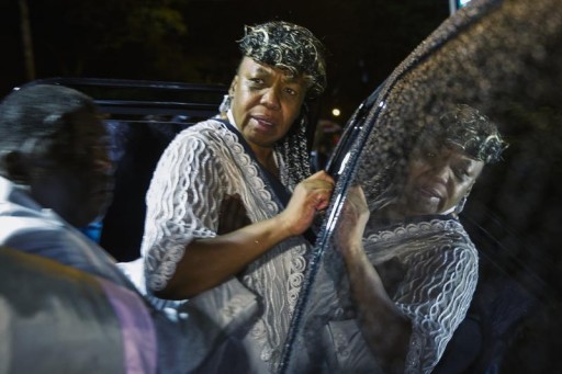 Gwen Carr (R), mother of Eric Garner, yells at a family member as she enters a car following Garner's funeral in New York July 23, 2014.  Reuters
