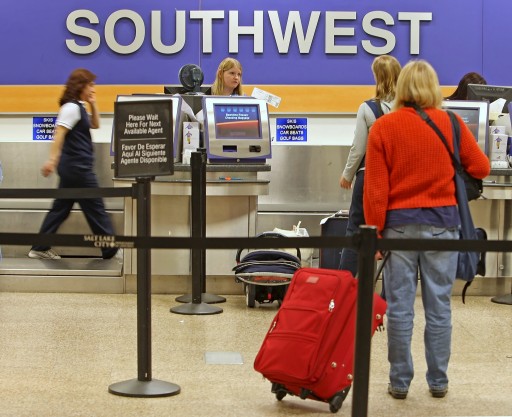 FILE -  Passengers wait to be ticketed at a Southwest Airlines counter at the Salt Lake City international Airport. EPA 