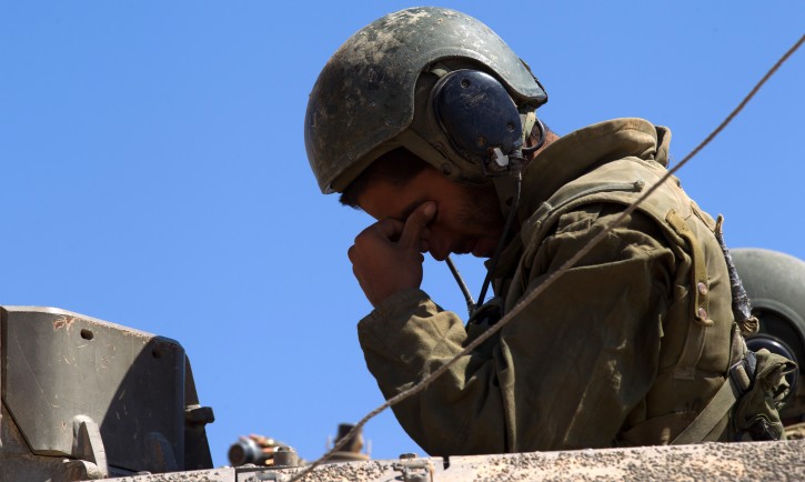  An Israeli soldier reacts on top a Markava tank as it leaves the Gaza Strip, 23 July 2014.  EPA
