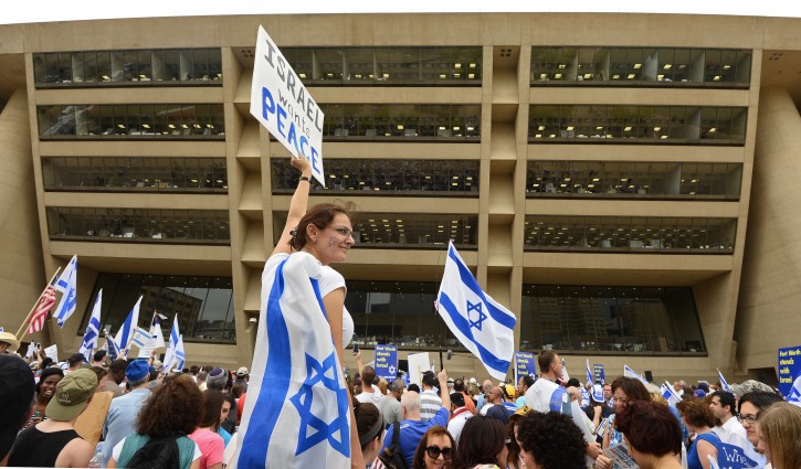 A woman holds up a sign showing her support for Israel during a rally outside Dallas City Hall in Dallas, Texas, USA, 30 July 2014. The Jewish Federation's Israel Solidarity Rally was to show support for Israel. The Israeli offensive in Gaza is on its 23rd day.  EPA/LARRY W. SMITH