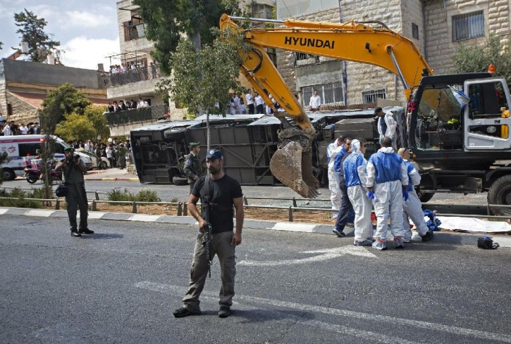 Israeli police officers stand guard at the scene of an attack in Jerusalem, Monday, Aug. 4, 2014. (AP Photo/Sebastian Scheiner)
