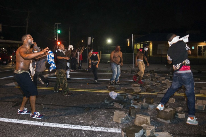 Protesters throw rocks and attempt to block the street after protests in reaction to the shooting of Michael Brown turned violent near Ferguson, Missouri August 17, 2014. REUTERS/Lucas Jackson