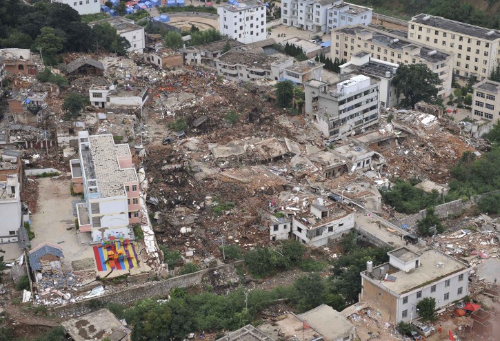 This aerial photo taken on Aug. 4, 2014 shows buildings toppled down by a 6.5-magnitude earthquake at the quake's epicenter in Longtoushan Town under Ludian County of Zhaotong, southwest China's Yunnan Province. The quake struck at 4:30 p.m. Sunday (Beijing Time) with a depth of 12 km. As of 2:00 p.m. Monday, the quake has killed 398 people and injured 1,801, while affecting more than a million others in Zhaotong and Qujing. (Xinhua/Xue Yubin) (lmm)