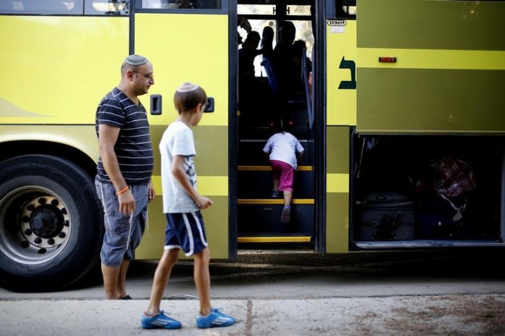 Residents of Kibbutz Sa'ad in southern Israel get into a bus after they left their houses following non-stop rocket attacks to southern Israel, on their way to Jerusalem August 25, 2014. REUTERS