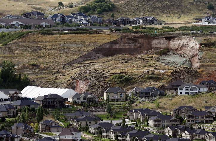 This Tuesday, Aug. 5, 2014 photo shows the area of a landslide in a hillside community of North Salt Lake, Utah. One home has been destroyed and at least a dozen others have been evacuated. (AP Photo/The Deseret News, Ravell Call) 