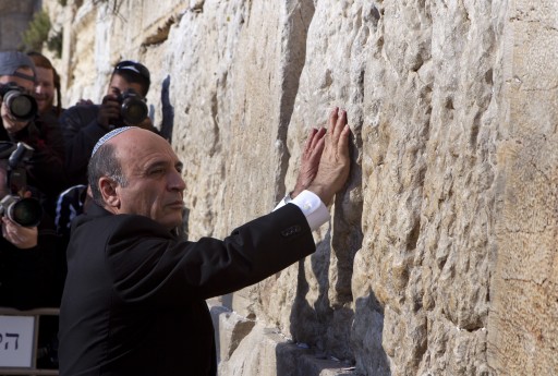 FILE - Shaul Mofaz leader of the centrist Israeli party Kadima places his hands on the Western Wall as he visits the holy site in Jerusalem, 28 March 2012. EPA