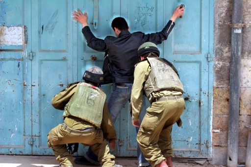 File Photo: Israeli soldiers check a Palestinian man.  EPA/AYMAN AL  HASHLAMOUN